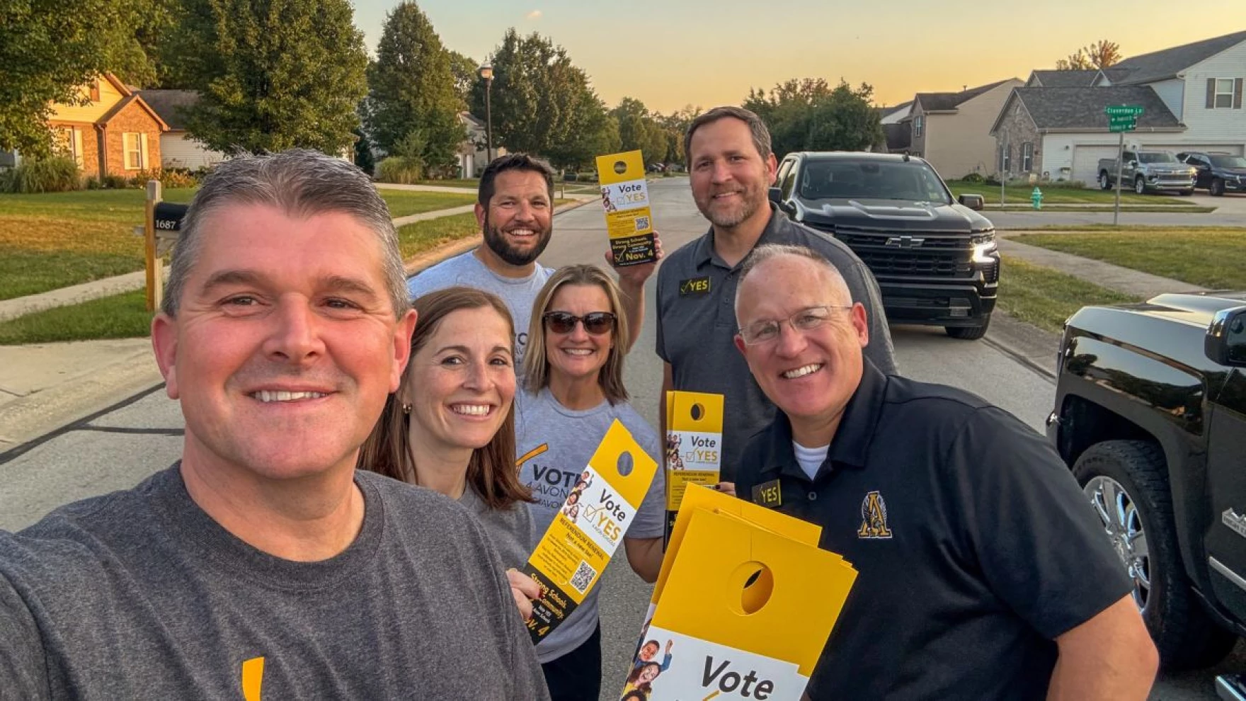 Avon Superintendent and five others holding Vote signs